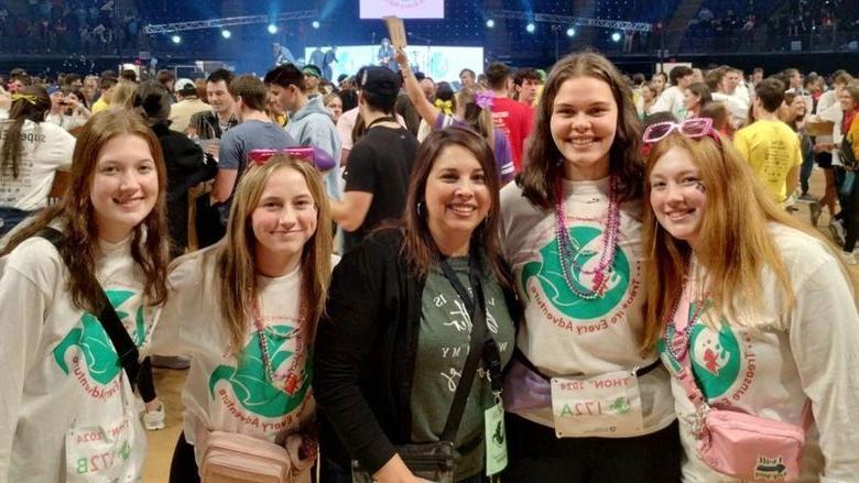THON dancers from Penn State DuBois gather on the floor at the Bryce Jordan Center during the 46-hour dance marathon for a photo. From left to right, Ella Wilson, Rachel Allegretto, director of student affairs at Penn State DuBois Rebecca Pennington, Madee Finalle and Abigail Morgo.